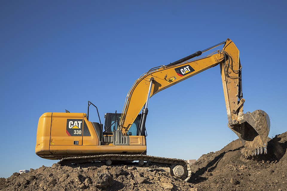 Tracked excavator with a digging bucket