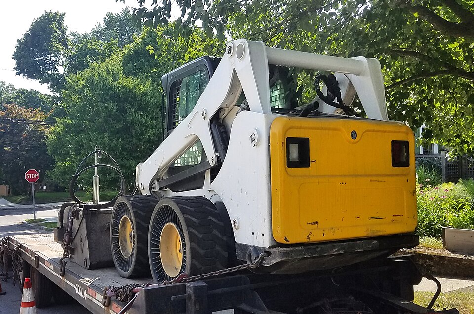 Wheeled skid steer loader with a front bucket